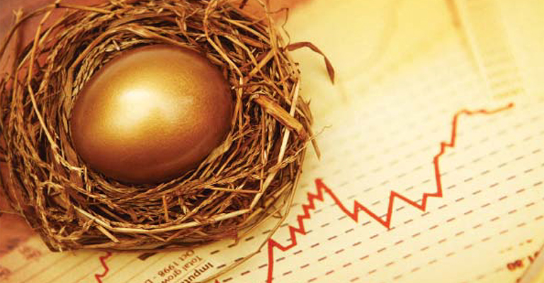Golden egg in a nest sitting on a financial graph