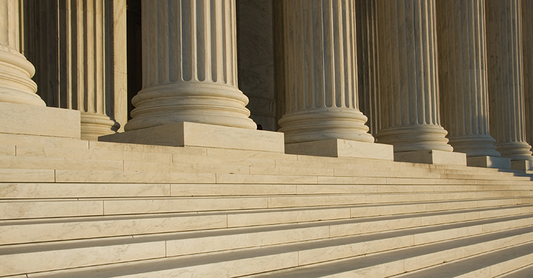 Stone steps and large columns leading to entry of government building
