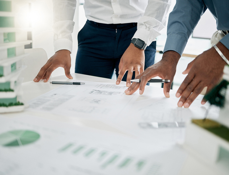 Two businessman’s hands resting on financial documents, representing financial opinion services